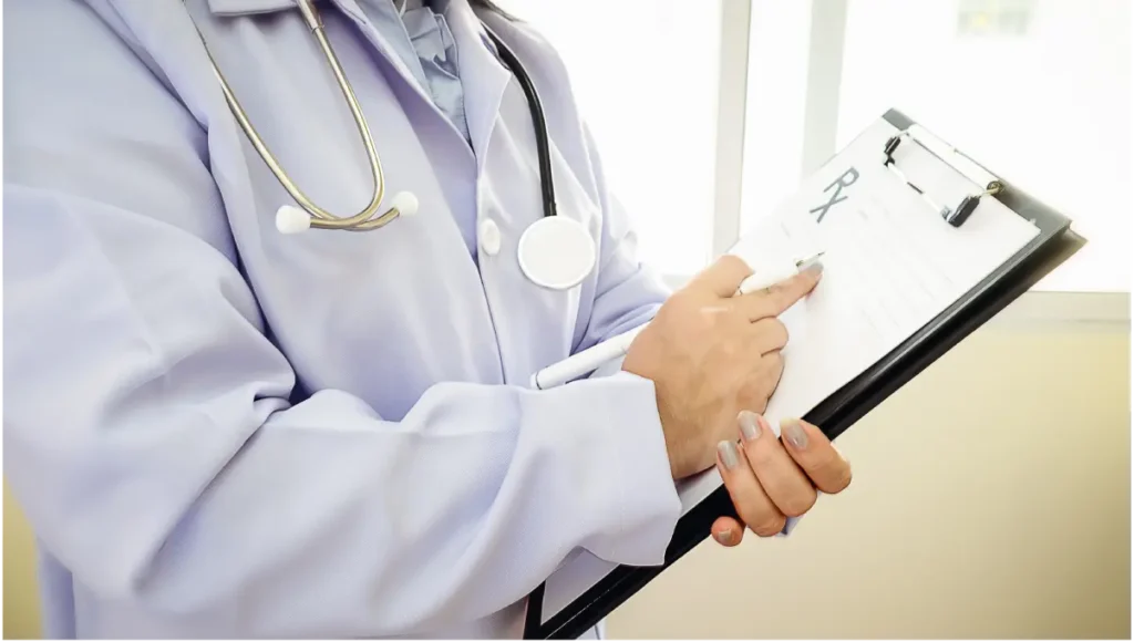 : SNF admissions coordinator reviewing digital patient intake workflow on a desktop screen in a skilled nursing facility